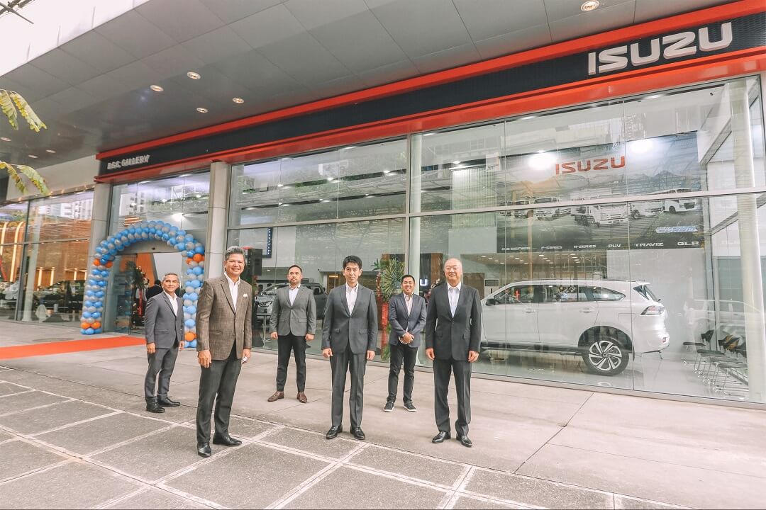 A group of men standing in front of a car

Description automatically generated with medium confidence